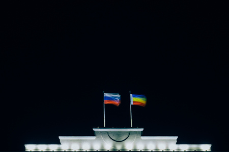 Flag of Russia and the Rostov region on the top of the building develop at nightの写真素材