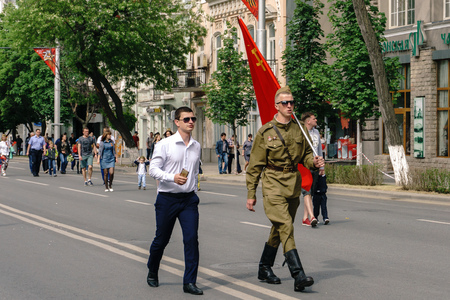 Rostov-on-Don / Russia - 9 May 2018: People with flags and in military uniform celebrate the great holiday May 9 Victory Day along the central streets of the city walking along the closed roadsのeditorial素材