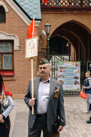 Rostov-on-Don / Russia - 9 May 2018: Thousands of people are walking along the central streets, carrying flags of Russia and the USSR and celebrating the Great Victory Day 1945のeditorial素材