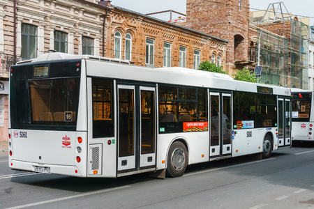 Rostov-on-Don / Russia - May 2018: City modern bus on the street in the city center rides behind hurrying passengersのeditorial素材