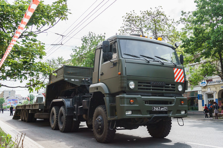 Rostov-on-Don / Russia - May 2018: A dark green tractor with a trailer for tanks stands on the central city streetの写真素材