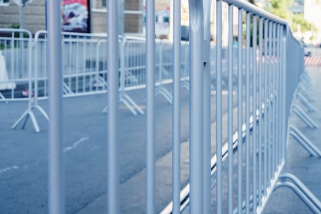 Portable metal grilles of light gray color for the obstruction of the territory and organization of...