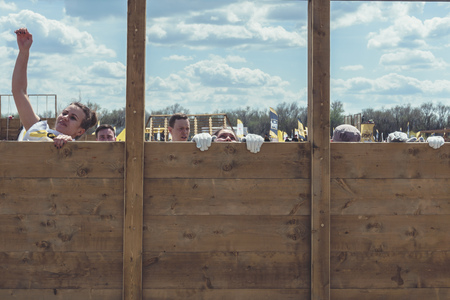 Rostov-on-Don / Russia - April 2018: Organized team run with obstacles in rough terrain with wooden structures on sandのeditorial素材