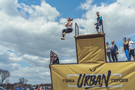 Rostov-on-Don / Russia - April 2018: Organized team run with obstacles in rough terrain with wooden structures on sandのeditorial素材