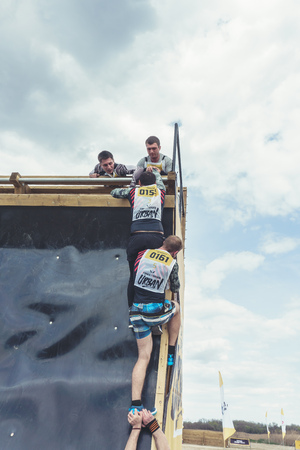 Rostov-on-Don / Russia - April 2018: Organized team run with obstacles in rough terrain with wooden structures on sandのeditorial素材