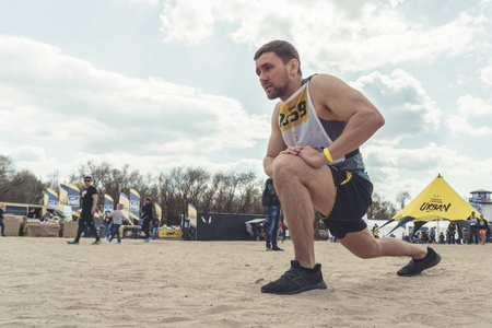 Rostov-on-Don / Russia - April 2018: Organized team run with obstacles in rough terrain with wooden structures on sandのeditorial素材