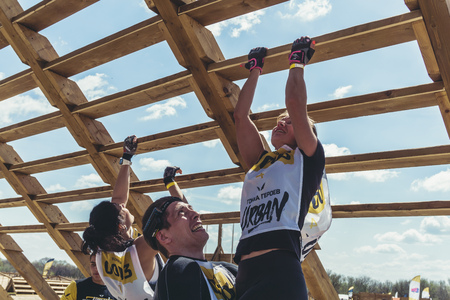 Rostov-on-Don / Russia - April 2018: Organized team run with obstacles in rough terrain with wooden...