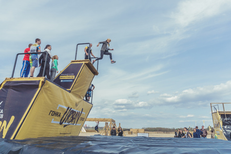 Rostov-on-Don / Russia - April 2018: Organized team run with obstacles in rough terrain with wooden structures on sandのeditorial素材