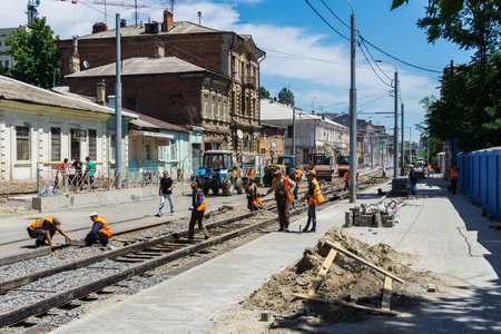 Rostov-on-Don / Russia - May 2018: Laying of new steel rails on wooden sleepers in a prepared mound of large crushed stone for new tram lines in the city centerのeditorial素材