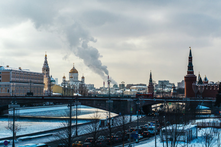 Moscow / Russia - february 2018: The Moscow Kremlin, the main temple and the high pipe of the boiler room emitting smoke into the sky near the Red Square on a cold day in winterのeditorial素材