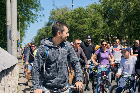 Rostov-on-Don / Russia - may 2018: a lot of people with children riding their bicycles through the blocked streets in the city center during the cyclists' parade on a sunny spring dayのeditorial素材