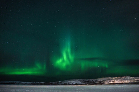 green northern lights over the tundra filmed on a long exposure in a frosty clear nightの写真素材