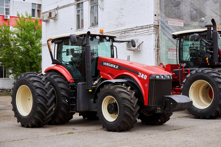 Rostov-on-Don / Russia - May 2018: a new large agricultural tractor in red on the street during the...