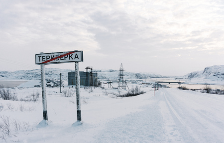 Teriberka, Murmansk region / Russia - January 2019: traffic sign informing you that you are leaving the Teriberka village, the road continues on the snowy tundra on a winter frosty dayのeditorial素材