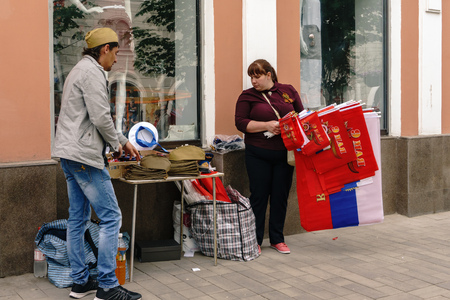 Rostov-on-Don / Russia - 9 May 2018: Street vendors on the tables in the middle of the street sell souvenirs, red flags, St. George ribbons and military symbolism in honor of the Victory Day holidayのeditorial素材