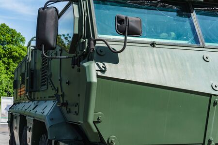 the front part of the cabin of a modern all-terrain vehicle for transporting soldiers during the battle, protecting them with thick armorの写真素材