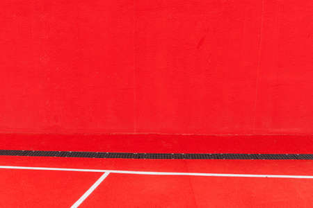 bright red corner of the playground on the wall and floor with white lines in the zone in the new city parkの写真素材