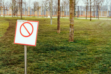 blank crossed-out prohibition sign on a well-kept green lawn for any purpose