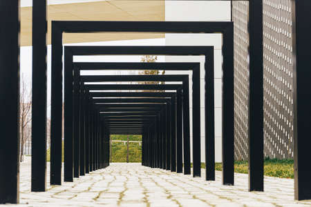 passageway under black square metal arches in the Park as an art objectの写真素材