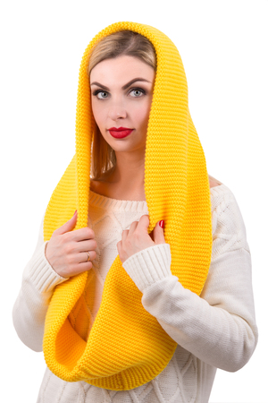 A beautiful young woman in a bright knitted scarf.の写真素材
