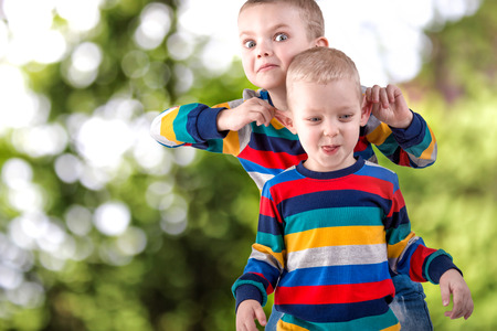 Two brothers play, have fun, make friends.Children dressed in the same clothes.の写真素材