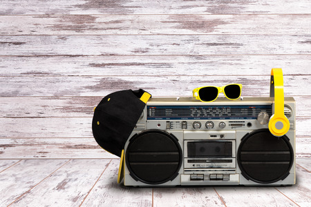 Vintage audio player with headphones.fashionable cap and sunglasses.Vintage style .The concept of the music Hip hop style.の写真素材
