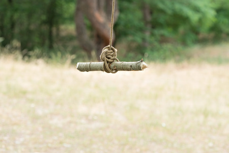 A homemade swing in the forest.Extreme rest.の写真素材