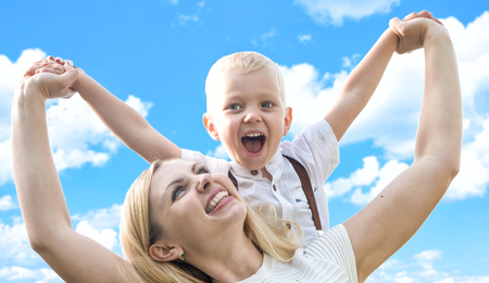 Mother and little son having fun playing together.の写真素材