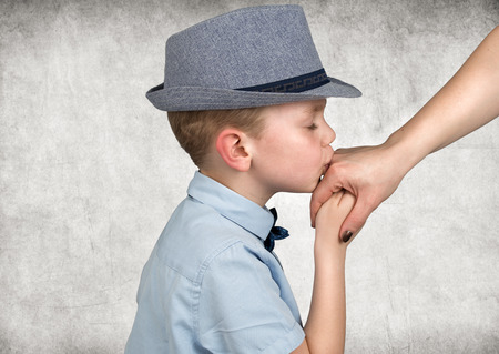 The boy kisses the hand of the mother.の写真素材