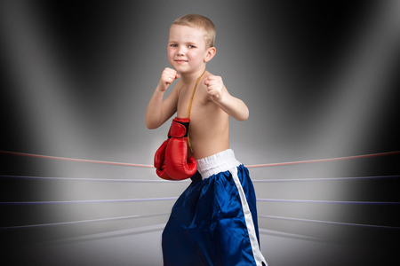 The child goes to his dream of becoming a boxer.Little champion in the ring.The big wins.の写真素材