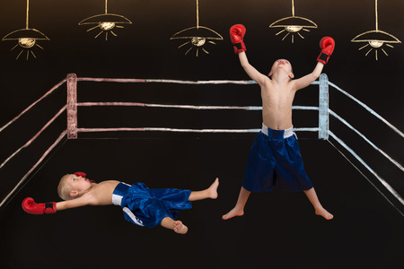 Boxing match of two brothers. Drawings in chalk on the wall.