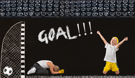 Two brothers play football.A goal in the opponent.Drawings in chalk on the wall.の写真素材