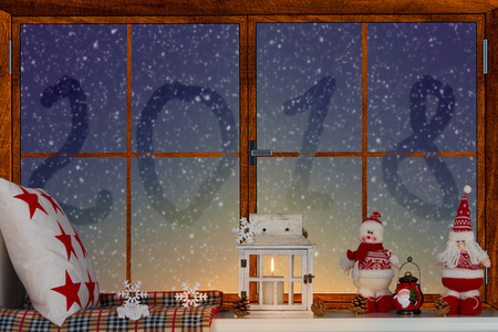 Merry Christmas and Happy Holidays! A beautiful decorated for Christmas window. 2018 written on the window.の写真素材