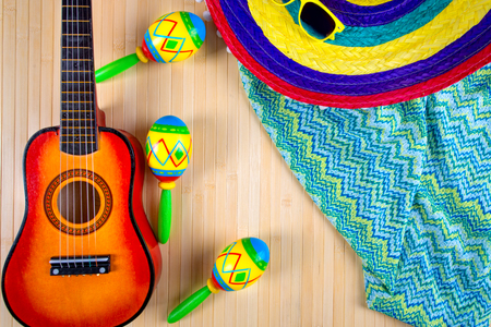 Mexico.Colored sombrero the guitar and maracas on a wooden background.の写真素材