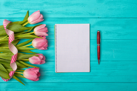 Valentine's Day background with bouquet of tulips and an empty notebook for romantic entries.の写真素材