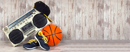 The concept of the music Hip hop style and sports. Vintage audio player, fashionable cap, sneakers...