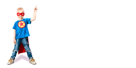 Portrait of a boy in a superhero costume isolated on white background.の写真素材