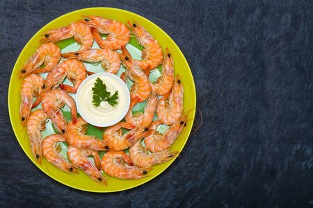 Boiled shrimp on a plate on a black background.の写真素材