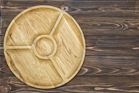 Wooden plate on wooden background.の写真素材
