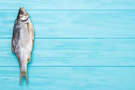 Dried ram fish on a wooden blue background.の写真素材