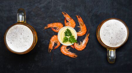 Boiled shrimp with cold beer. Shrimp on a black background.の写真素材