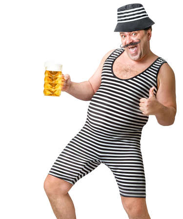 Cheerful man in a striped suit with a glass of cold foamy beer.の写真素材
