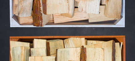 Wooden boxes with firewood on a black background.の写真素材