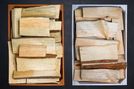 Wooden boxes with firewood on a black background.の写真素材