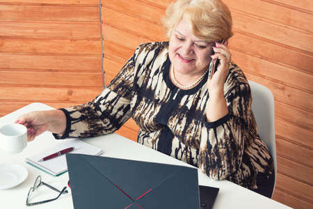 Woman in quarantine for Coronavirus works at home. Talking on the phone.の写真素材