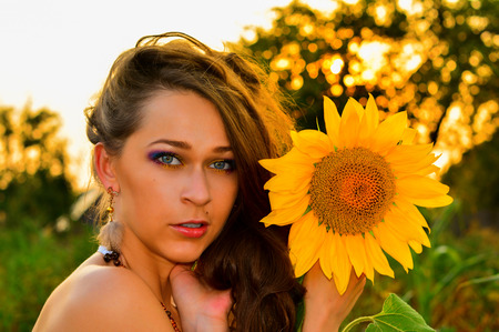 beautiful model with a sunflowerの写真素材