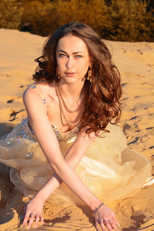 Gold Fashion Model dresses, woman in golden silk cloth beautiful girl looking at the sky the starsの写真素材