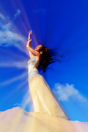Gold Fashion Model dresses, woman in golden silk cloth beautiful girl looking at the sky the starsの写真素材