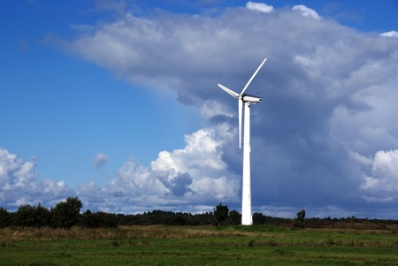 Wind turbine on a background of  blue sky and cloudsの写真素材