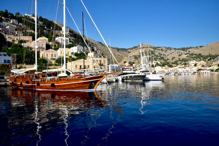 Yacht on anchor in harbour at Symi island Greeceの写真素材